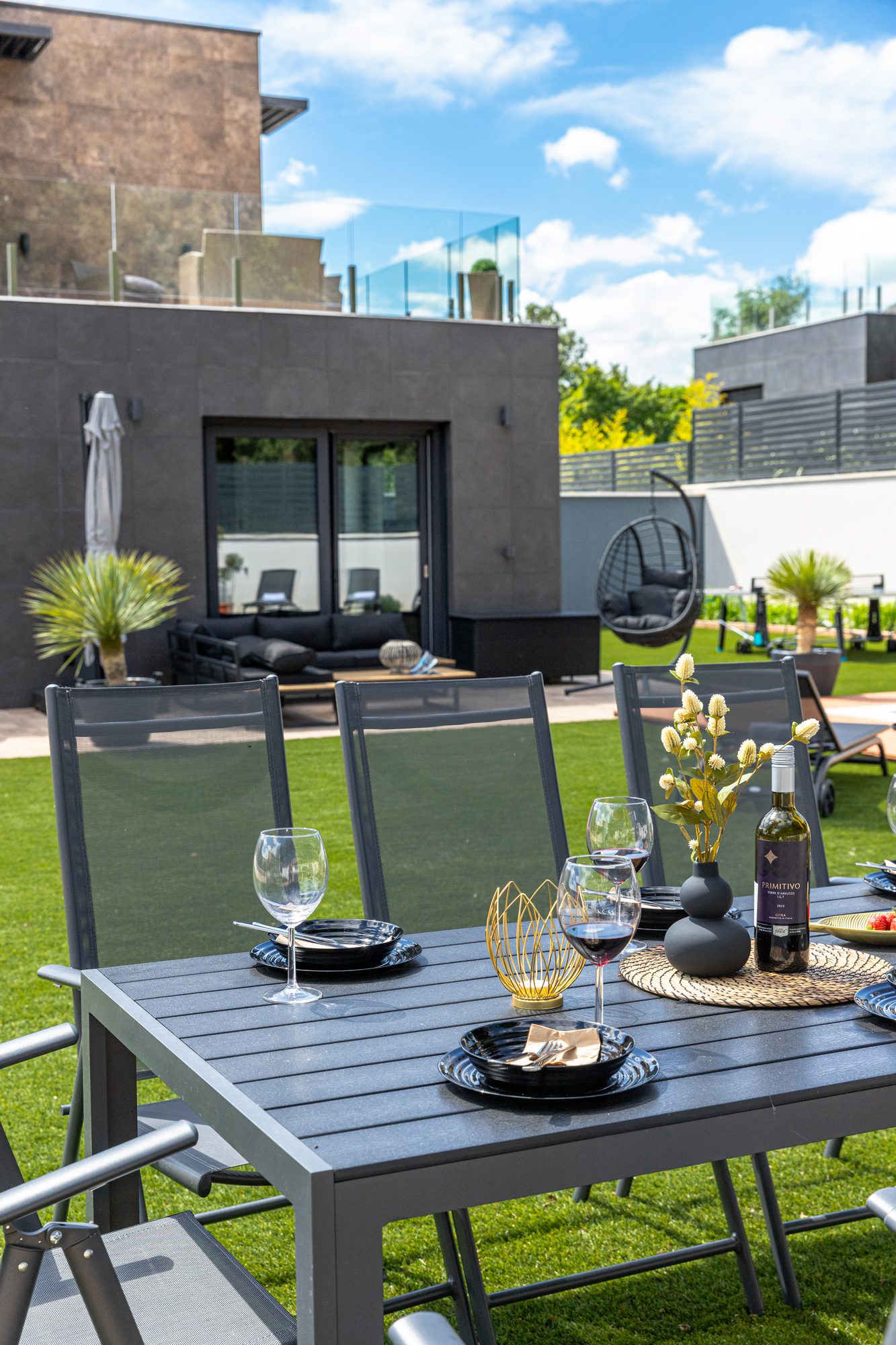 Lake Balaton villa accommodation - Villa Porta Verde I outdoor dining area with modern building and green lawn