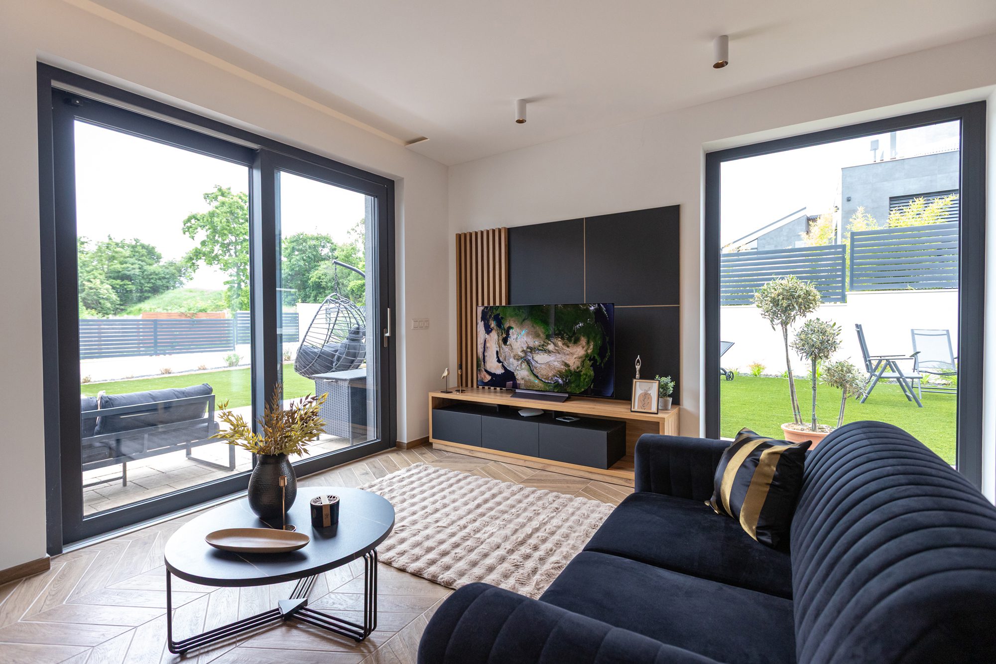 Living room villa rental Lake Balaton - Villa Porta Verde II spacious living room with dark velvet sofa and large windows